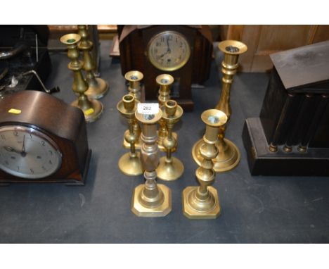 Three pairs of various brass candle sticks and a single brass candle stick