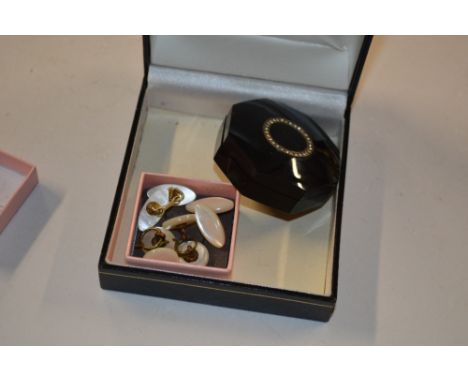 An octagonal shaped powder compact and two pairs of mother of pearl cuff links  
