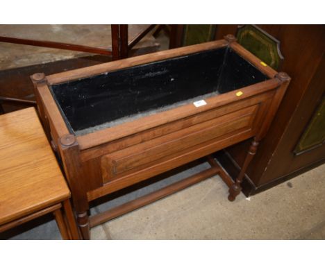 A mahogany and metal lined plant trough