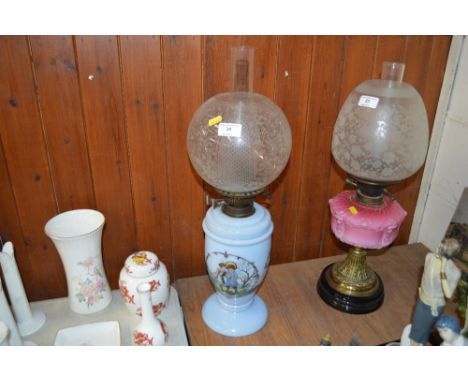 A late Victorian blue glass and figural decorated oil lamp with etched glass shade