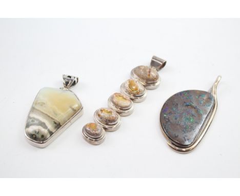 Three silver stone set pendants including a boulder opal 