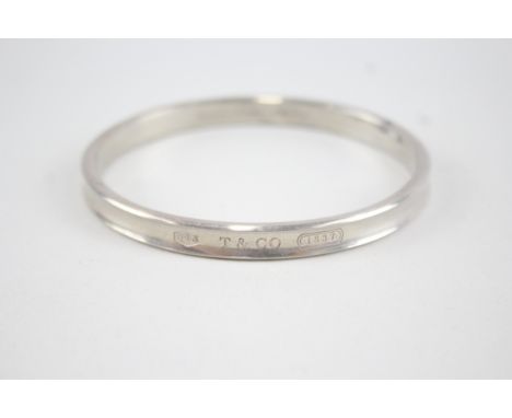 A silver bangle by Tiffany and Co 