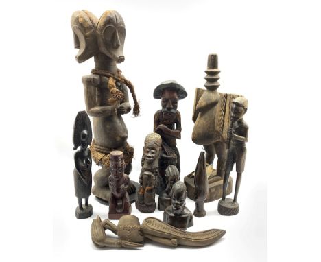 Group of ten carved figures, to include an African three-headed carved figure with plaited   accessories, H63cm, a carved Cal