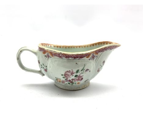 18th century porcelain sauceboat hand-painted with floral sprays beneath a pink scale border, L20cm 