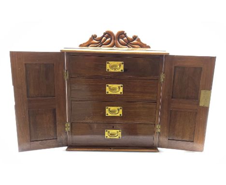 Late Victorian walnut specimen or cutlery cabinet with carved pediment, fielded panel doors each with Art Nouveau pierced bra