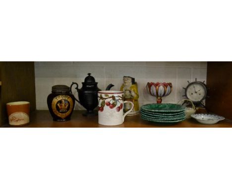 A shelf of decorative ceramics including Wemyss, Copeland, a Toby jug, cranberry glass, a timepiece in the form of a ships wh