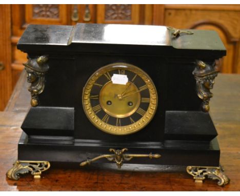 A 19th century black slate mantel clock of architectural form decorated with gilt metal Greek god caryatids and scroll feet, 