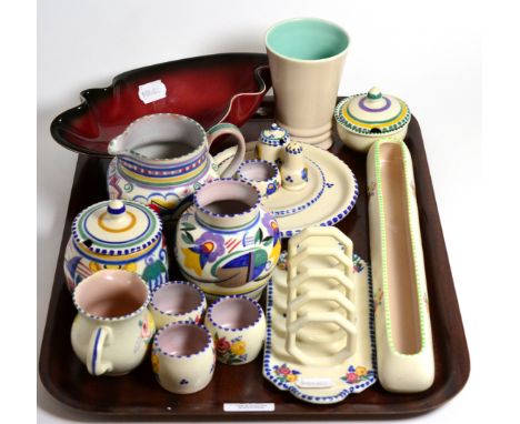 A collection of Poole pottery including two small vases, small cruet set, two jugs, toast rack, three egg cups, side plate, t