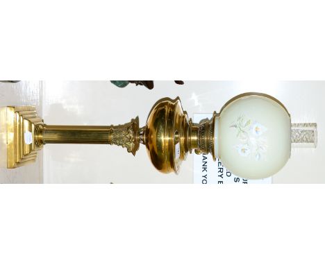 A brass Corinthian column oil lamp with shade, copper kettle and a brass jam pan 
