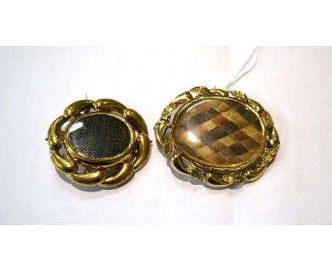 A Victorian revolving mourning brooch, a glazed plaque containing hair work and a photographic portrait verso, in a scroll fr