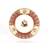 A 19th Century porcelain cabinet plate, with painted floral panels and central armorial crest;