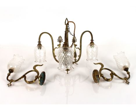 A brass Art Nouveau three branch light fitting, with dimpled glass tulip shaped shades and a pair of matching wall lights&nbs