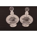A pair of heavy cut crystal decanters, with profuse hobnail pattern and fruit and foliage decoration
