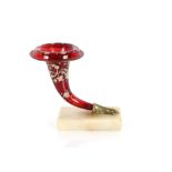 A 19th Century ruby glass Cornucopia hand vase, with floral decoration on onyx plinth, 18cm high