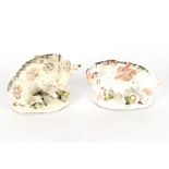 A pair of early 19th Century porcelain figures of boars, on naturalistic flower and acorn strewn