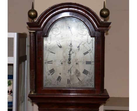 A Georgian mahogany and satin wood inlaid long case clock, the arched hood surmounted by brass orbs and flanked by reeded col