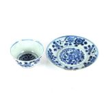 An 18th Century Chinese blue and white cup and saucer, with prunus decoration