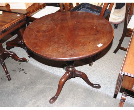 A George III mahogany tripod occasional table, raised on birdcage movement and baluster column terminating in pad feet, 74cm 