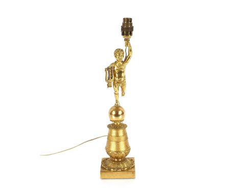 An Ormolu table lamp, in the form of a putti with lyre stood on a ball above foliate column and square plinth, 44cm high over