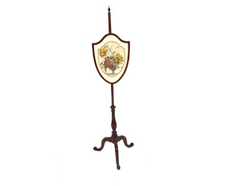 A 19th Century mahogany pole screen, the shield shaped banner decorated with printed fabric, raised on a turned column and sc