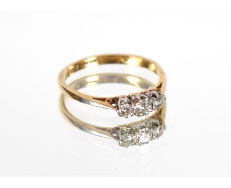 An 18ct gold and platinum three stone diamond ring 