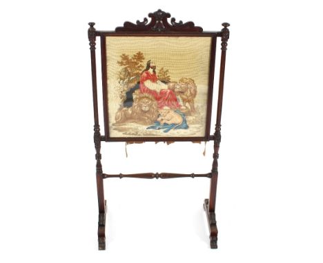 A 19th Century mahogany framed fire screen, the needlework panel depicting an allegorical scene beneath foliate cresting rail