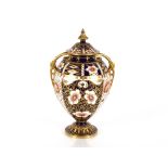 A Royal Crown Derby Imari pattern baluster vase and cover, heightened in gilt, 30cm high AF ; and