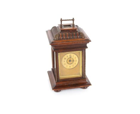 A 19th Century Symphonion musical clock, in walnut case fitted brass carrying handle, 38cm high and five 4&frac12;" discs
