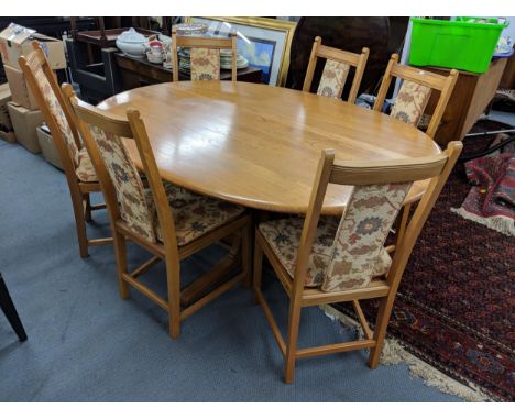 A blonde Ercol oval dining table on a quadruped base with six Ercol dining chairs with upholstered seats and back, Location:A