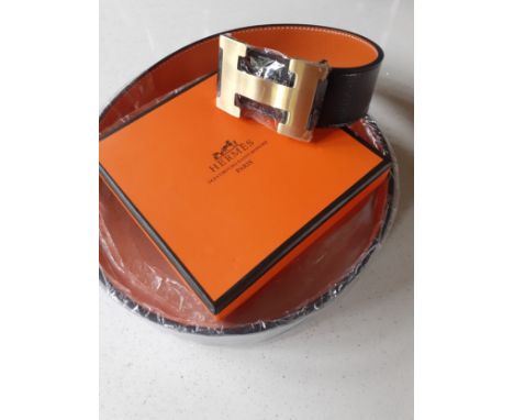 Hermes- A brand new gents Togo grain reversible noir/orange leather belt having a brushed gold tone H buckle, Hermes size 44/
