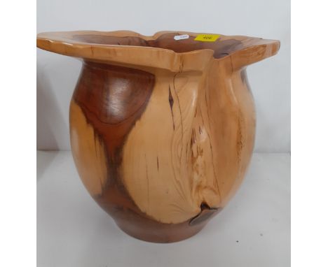 A Terry Harvey hand turned yew planter, label and carved insignia to base, 28cm High x 15cm internal diameter and 29cm outer 