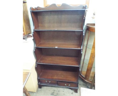 A waterfall effect 3 shelf bookcase with 2 drawers under 