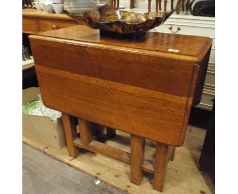 A 2'6 oak gate leg style dining table 