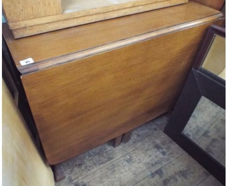 A gate leg table with cupboard under 