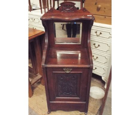 An Edwardian walnut coal perdoniam with mirror and shelf back