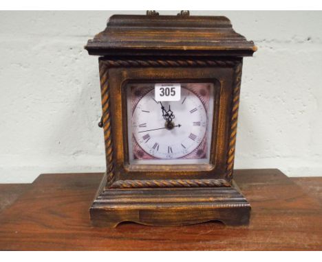 An antique style quartz mantle clock fitted with interior secret drawers