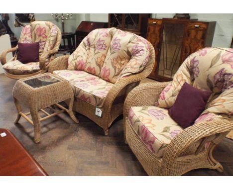 A good quality cane conservatory suite comprising swivel arm chair, 2 seater sofa (143cm approx), matching easy chair and a c