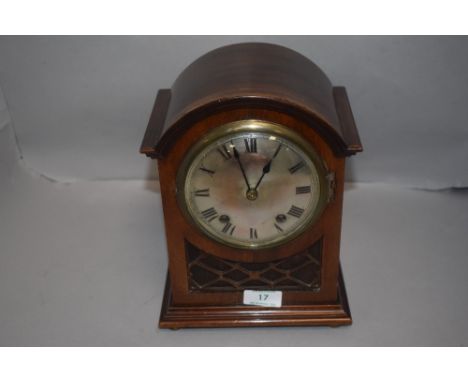 An Edwardian bracket clock having mahogany case with fret worked frontage domed dial and chime