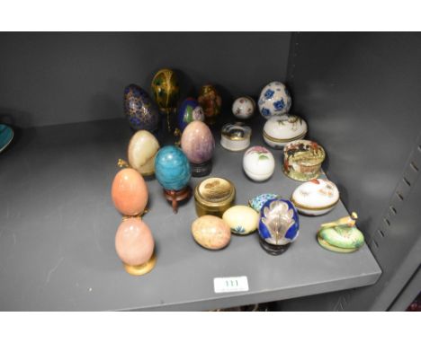 A selection of egg ornaments including stone turned, decorated papier mache, ceramic and cloisonne