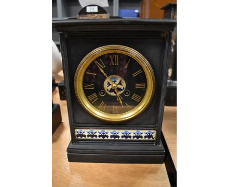 An antique Arts and Crafts slate mantel clock with floral tile insert