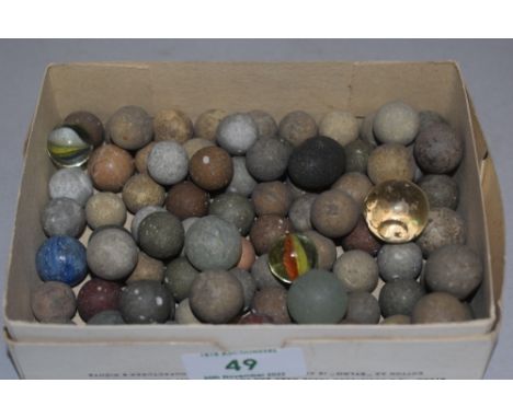 A selection of antique games counters balls marbles and shot pieces in glass stone and ceramic