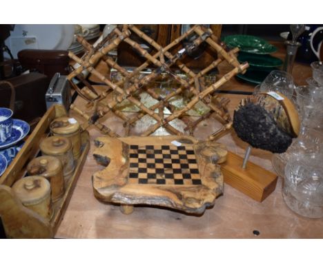A selection treen wood items including a bamboo bottle rack, a spice jar set and a burr wood games board.