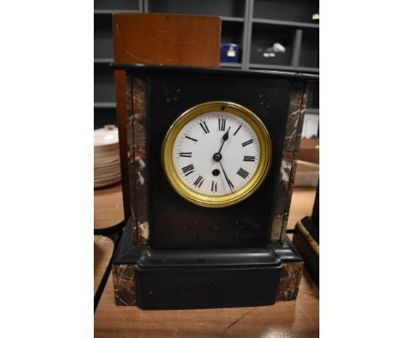 A Victorian French mantel clock having marble inserts and enamel dial