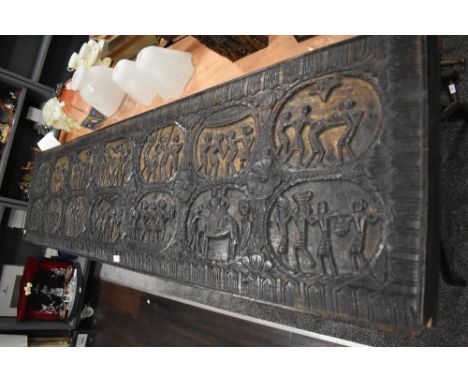 An antique hard wood carved panel removed from a palace in Orissa India, depicting fourteen cartouche scenes of North East In