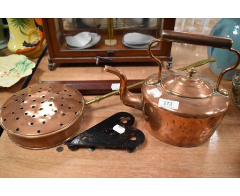 An antique copper stove kettle with a chestnut roaster trivet and telescope