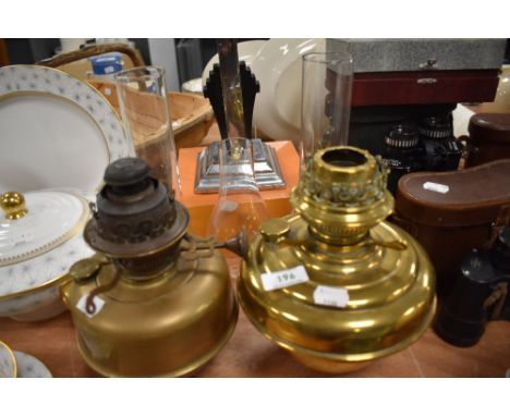 Two Victorian oil burning lamp bases both in brass
