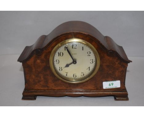 An early 20th century mantel clock having scroll work style case and 8 day movement