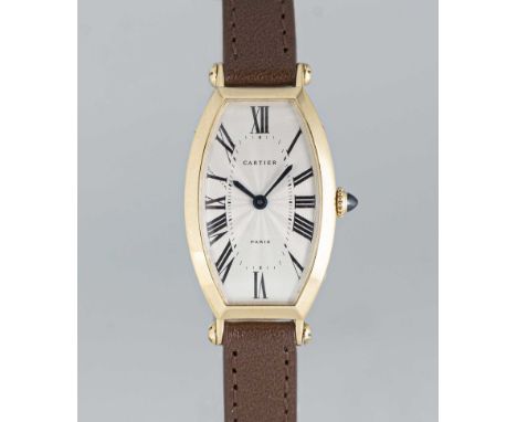 A FINE LADIES 18K SOLID GOLD CARTIER PARIS CINTREE TONNEAU WRIST WATCHCIRCA 1990sMovement: Manual wind, signed Cartier.Case: 