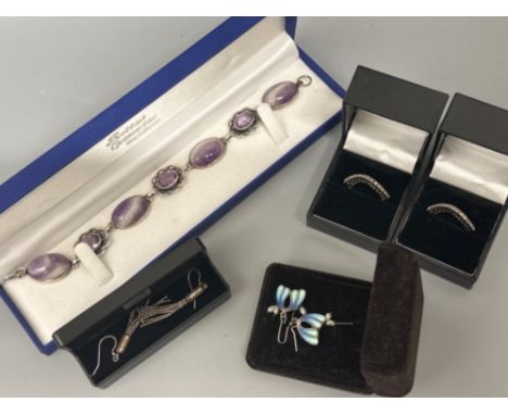 Five pieces of silver jewellery includes two cz rings, enamel &amp; plain earrings and purple stone bracelet 