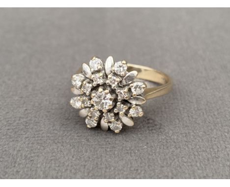 18ct gold diamond cluster ring featuring a .10ct centre stone weighing 4.88 grams Size I